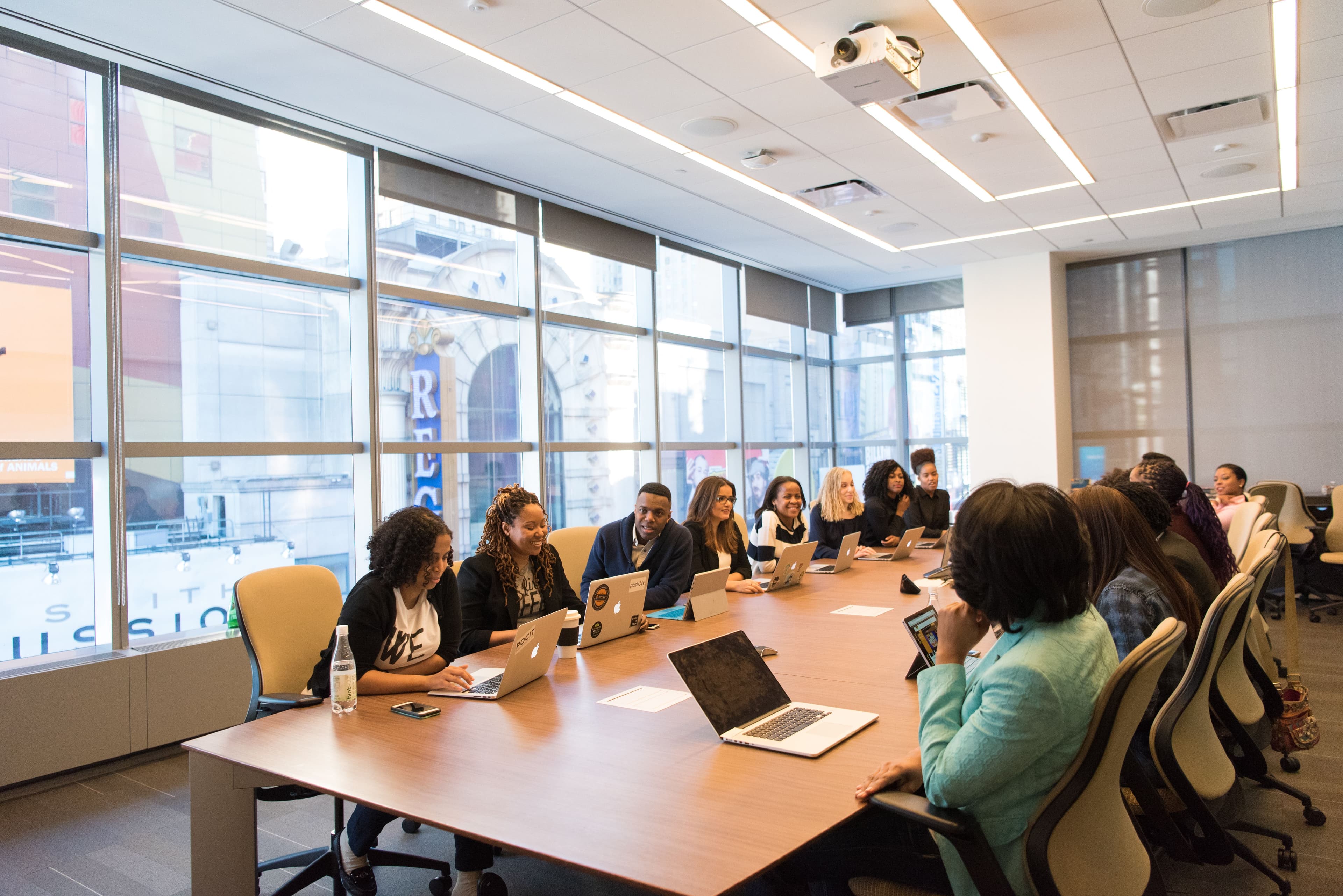 Professionals in discussion around a boardroom conference table